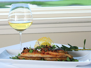 Salmon dish and glass of wine